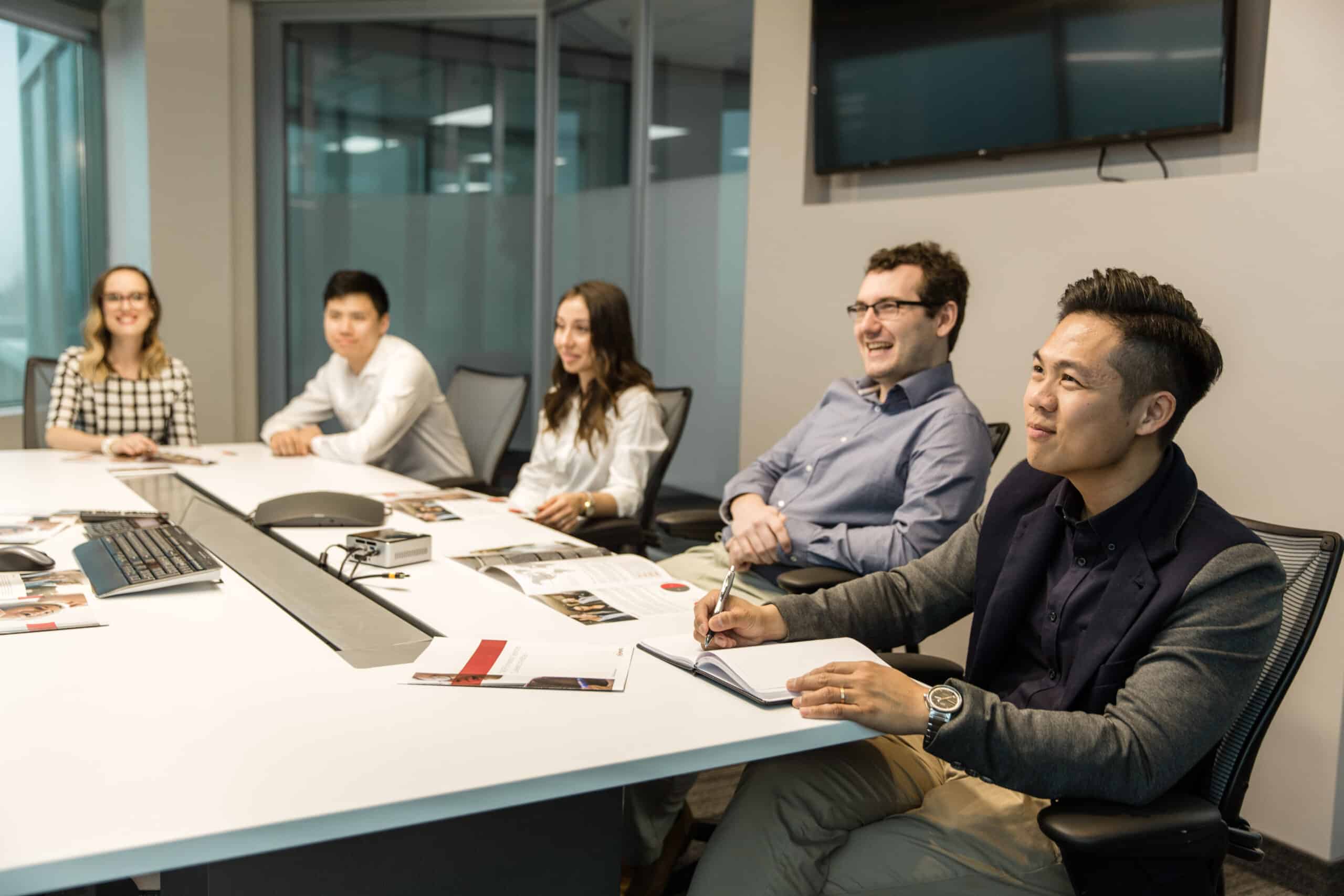 A group of people smiling during a meeting