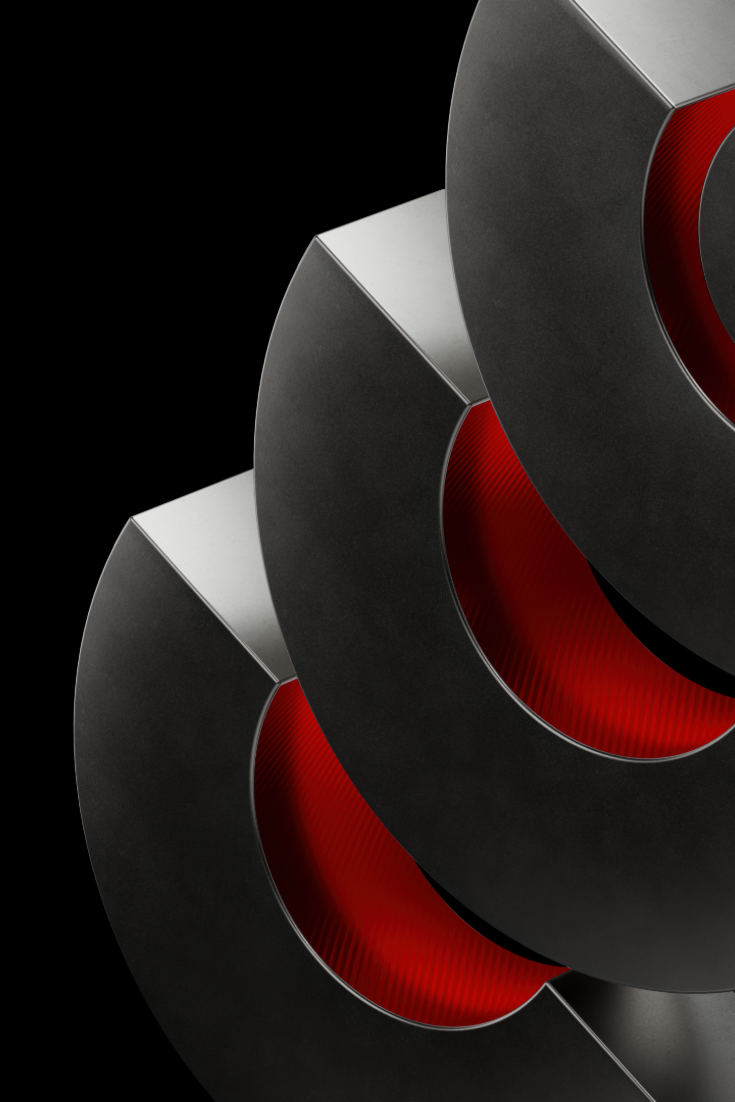 Close-up of overlapping dark metal rings with red inner surfaces against a black background.