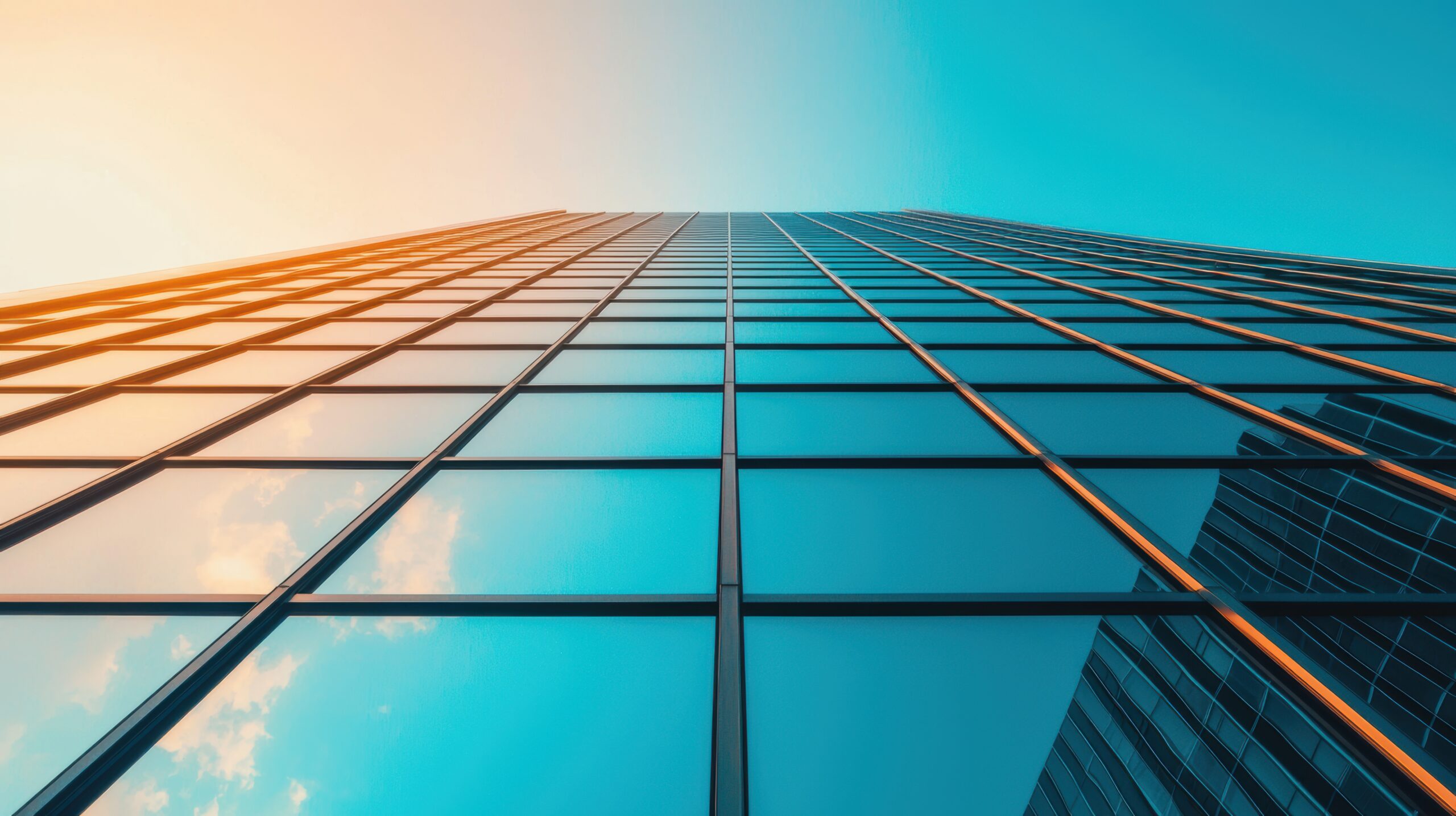a close up shot of the reflective glass facade of a skyscraper, creating abstract patterns and reflecting the surrounding cityscape.