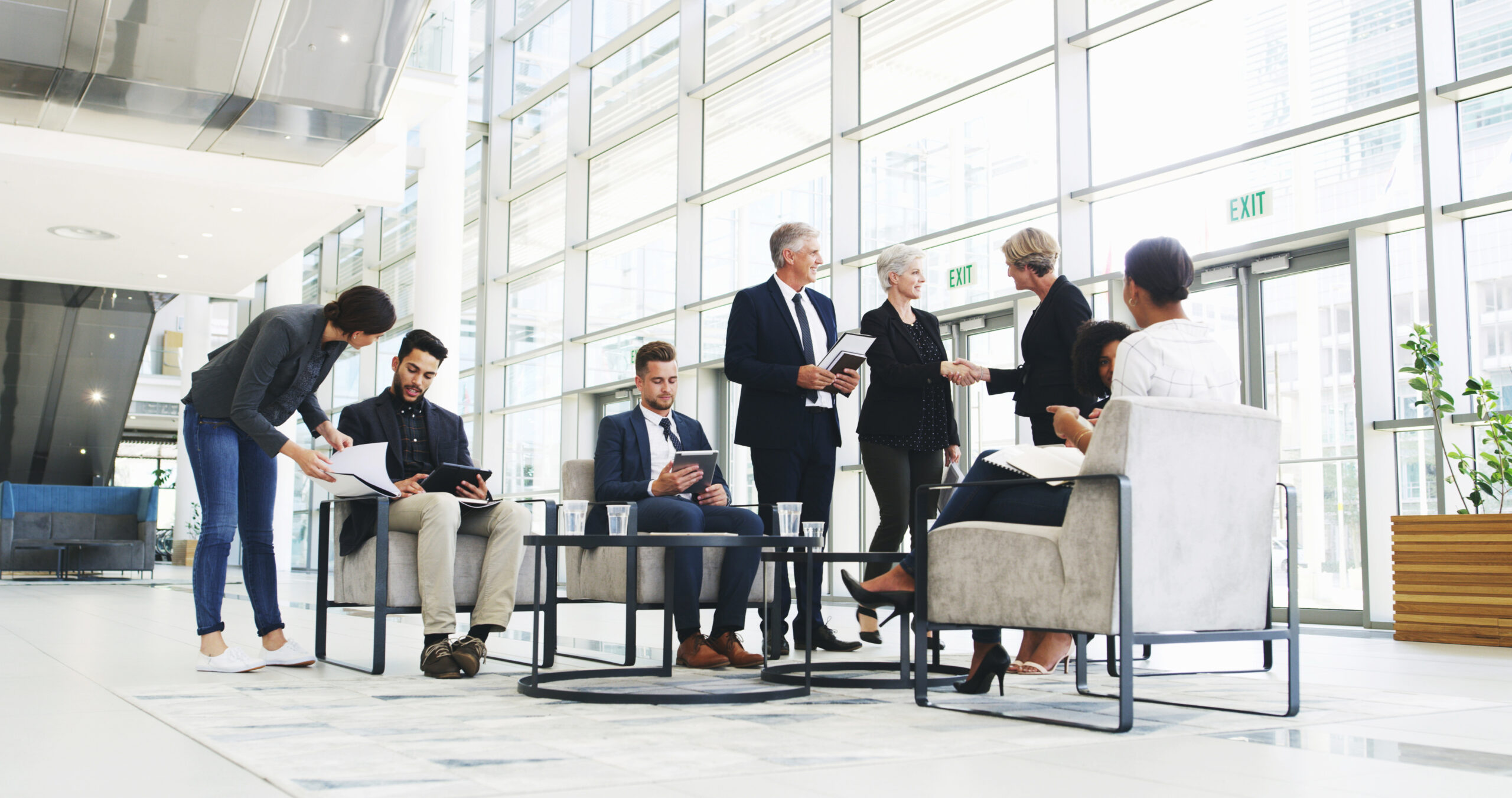 collaboration, development and meeting with business people in lobby of office for planning or strategy, coaching, management and training with employee team in discussion of company workplace