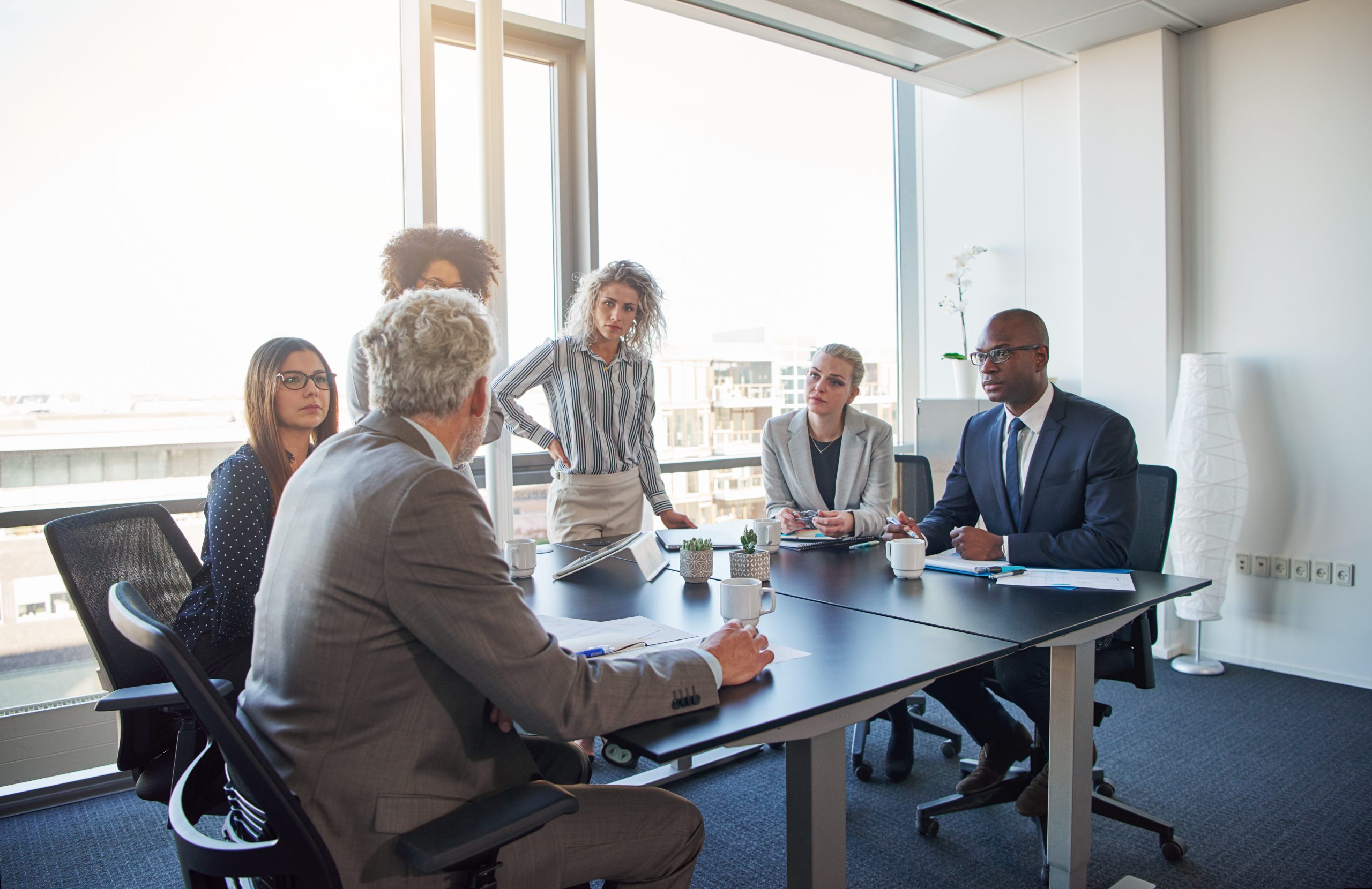 executives talking business together in an office boardroom
