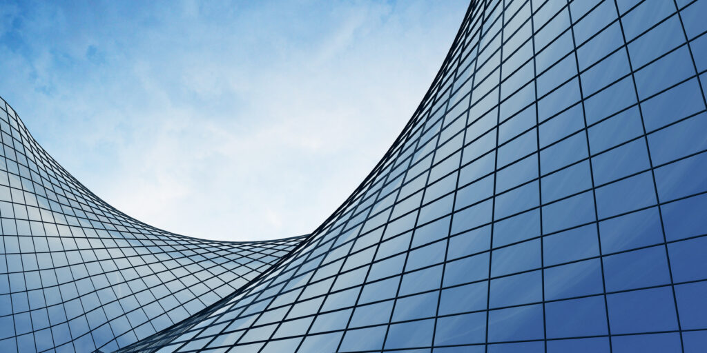 view of the clouds reflected in the curve glass office building.