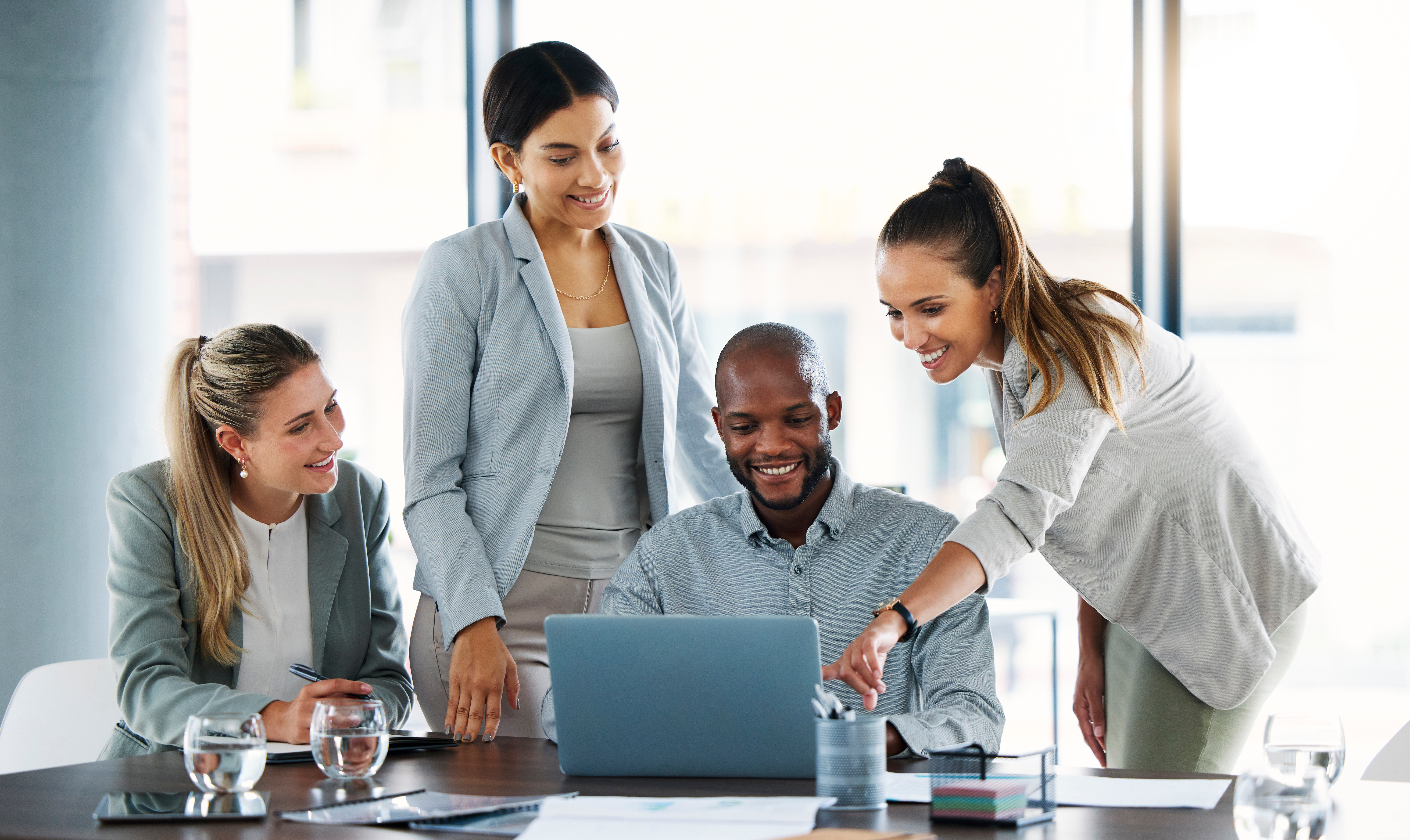 business people, laptop and meeting for team idea, strategy or collaboration on group project at the office. employee workers in teamwork, planning or brainstorming for online marketing on computer