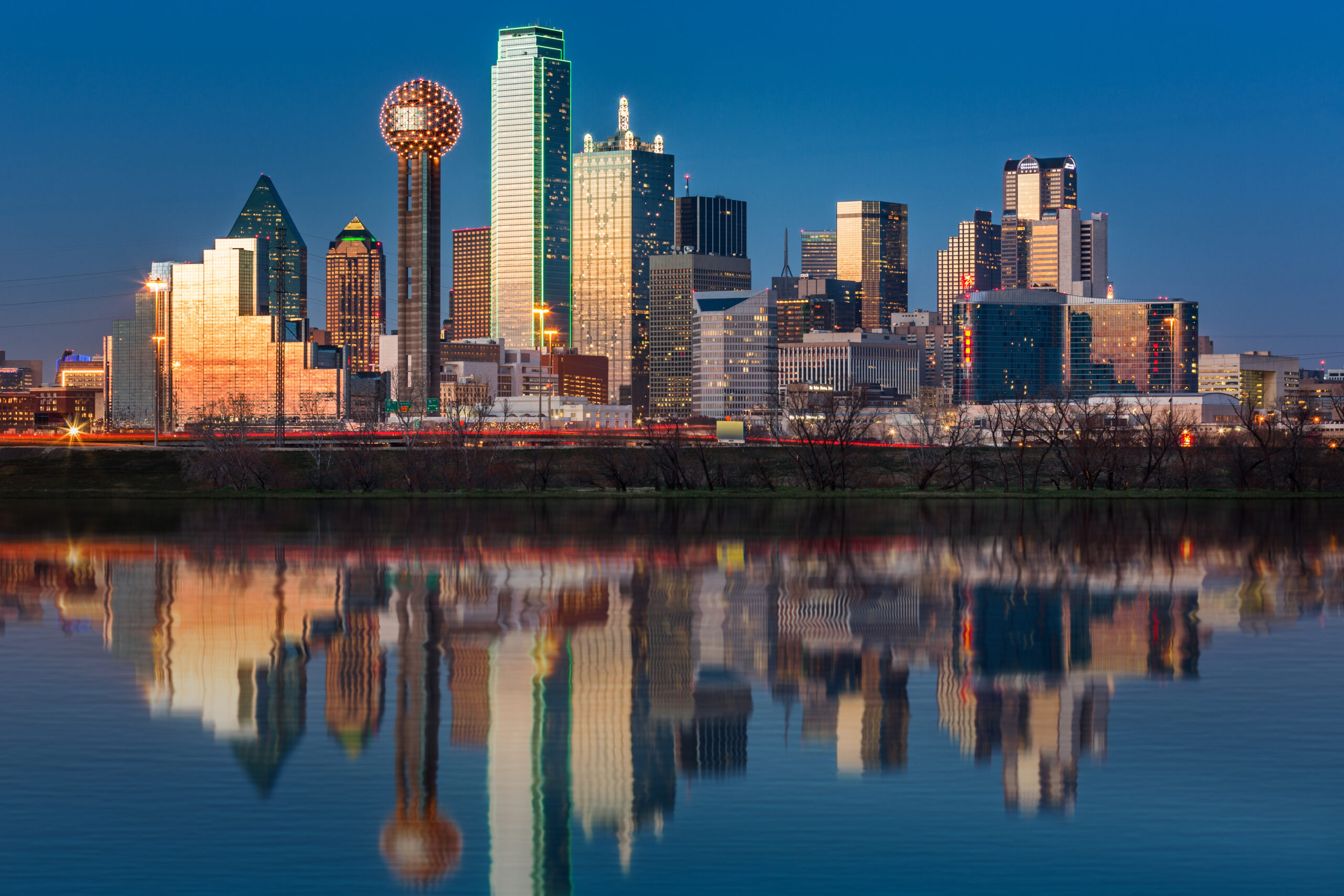 dallas skyline reflected in trinity river at sunset