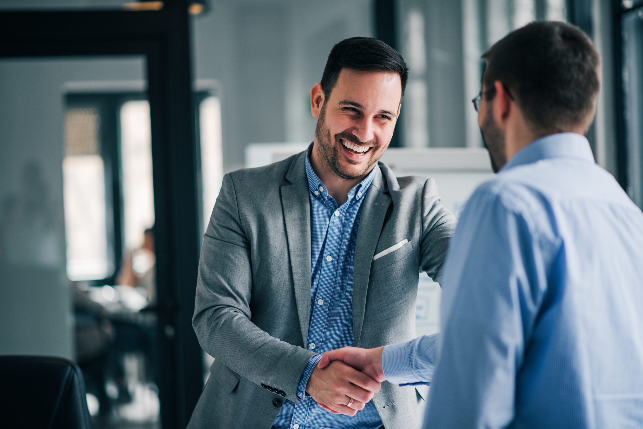 portrait of cheerful young manager handshake with new employee.